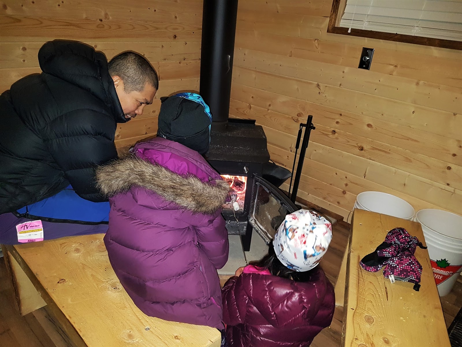 Warming up by the fire at Reesor Lake Backcountry Hut