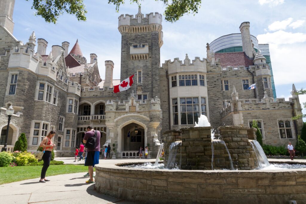 Casa-Loma-entrance-exterior-architecture-foutain-with-visitors-daytime_Attractions_Image-large